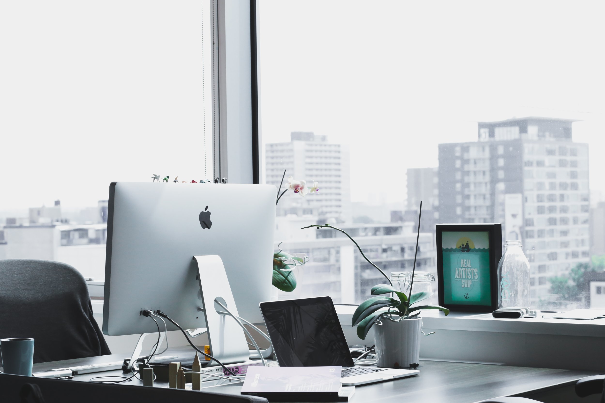 photograph of an office desk overlooking a metropolis skyline