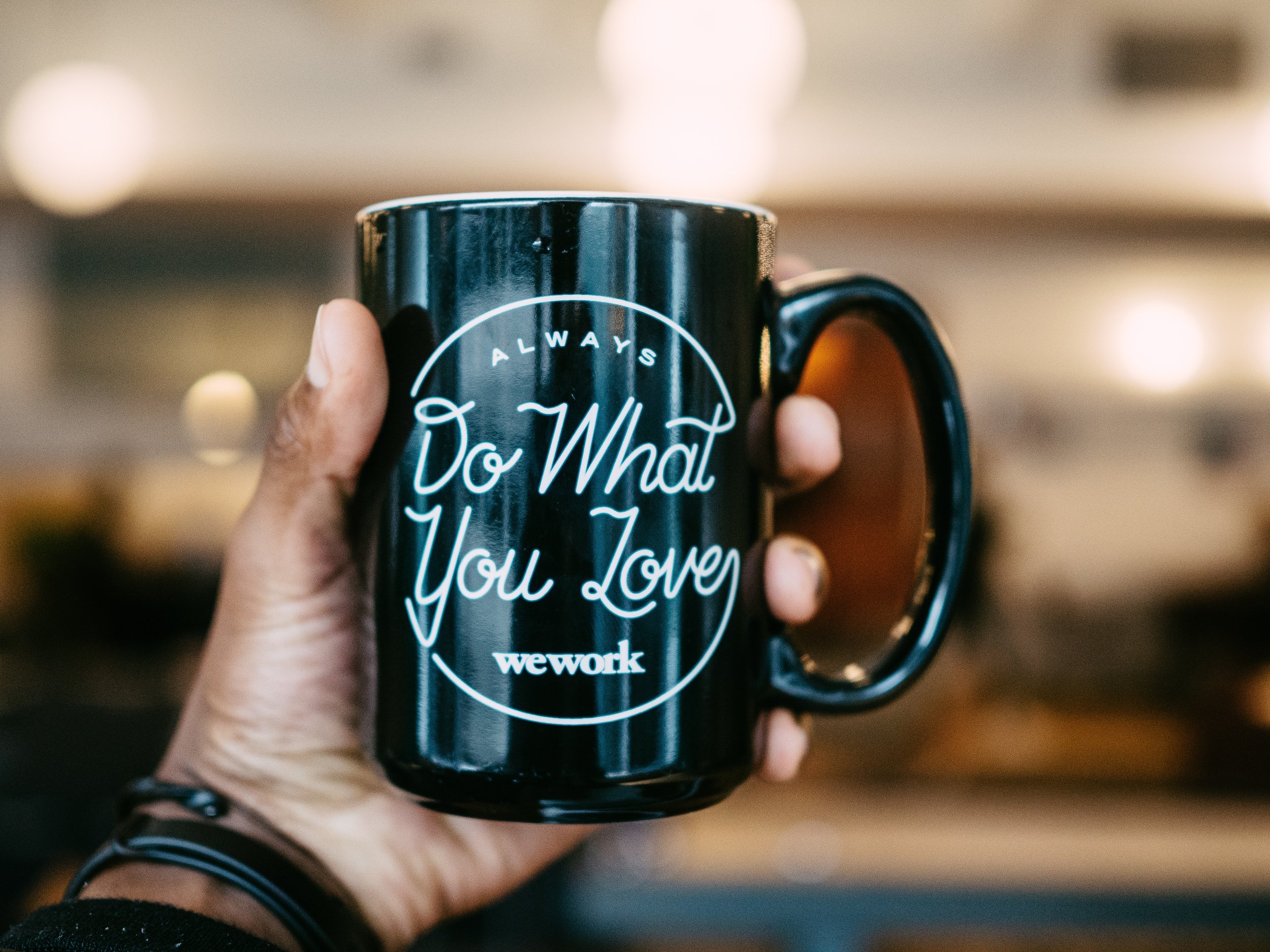 photograph of hand holding coffee mug