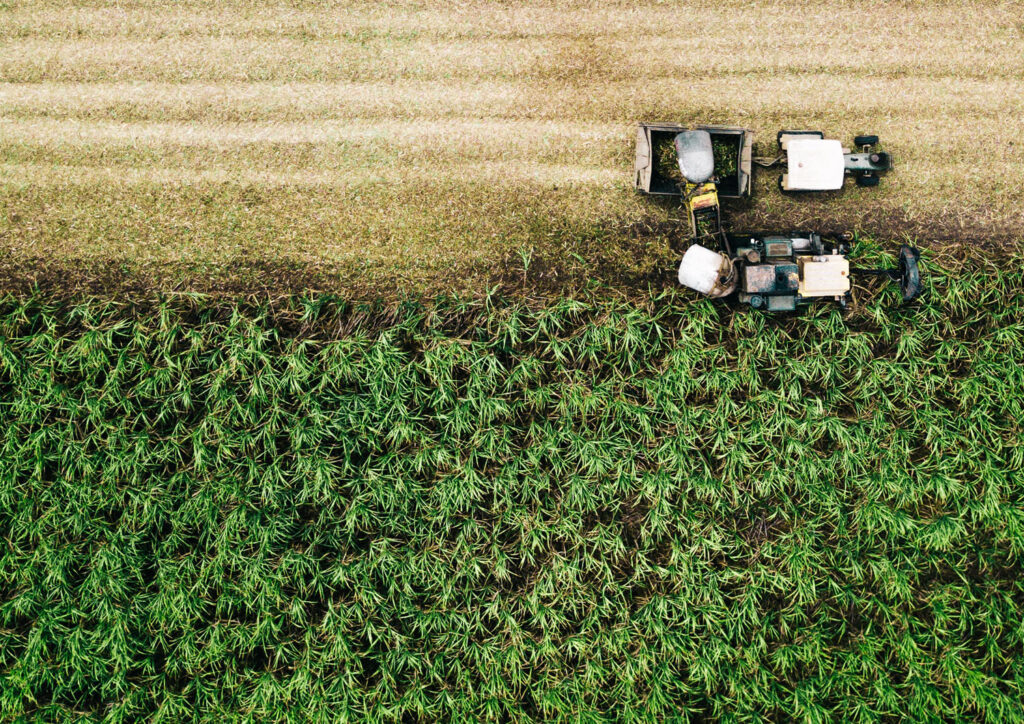 photograph of tractor running through field