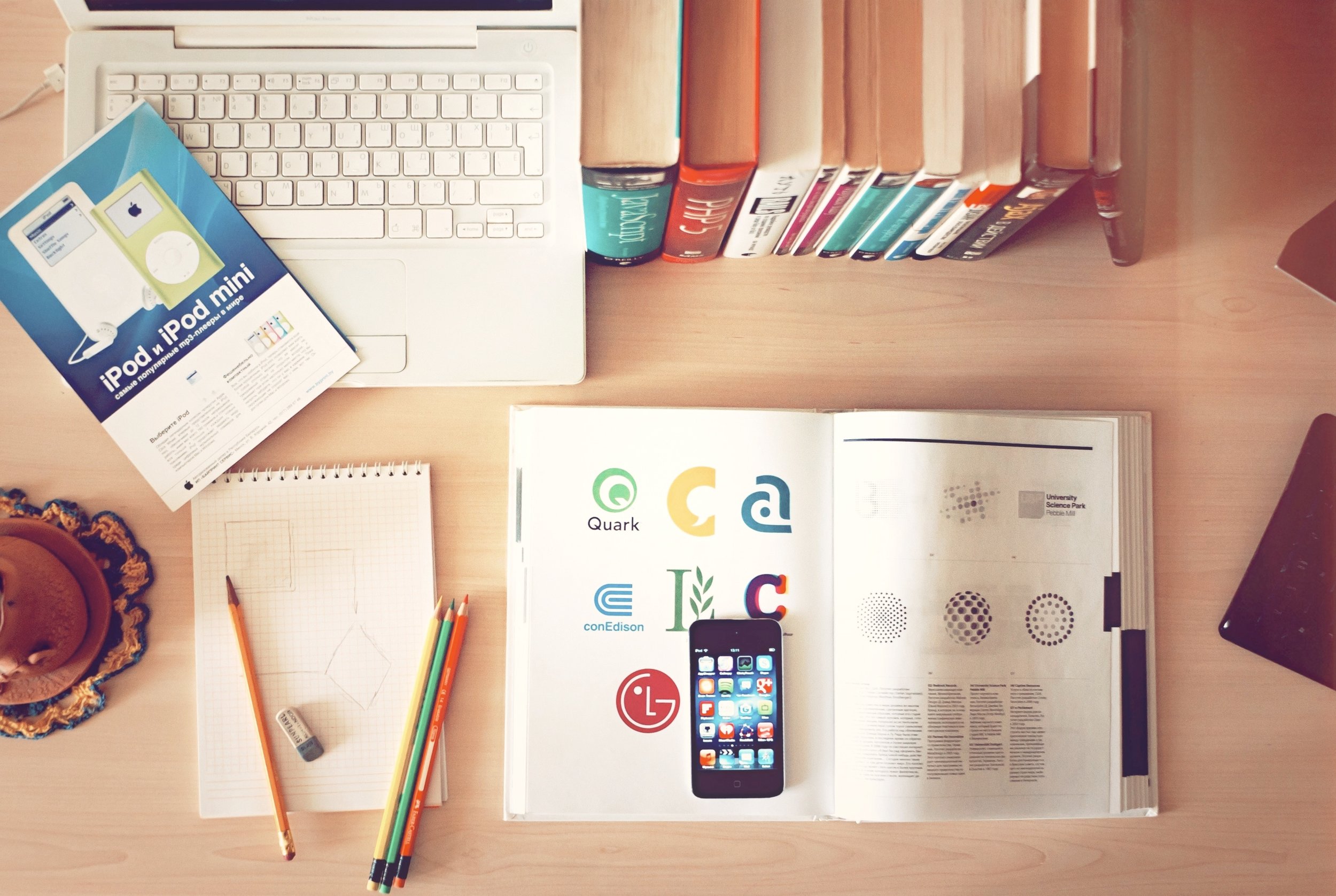 photograph of a desk (top view) with a phone and open book