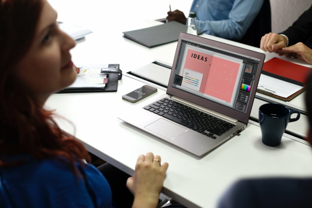 photo of woman smiling in front of laptop