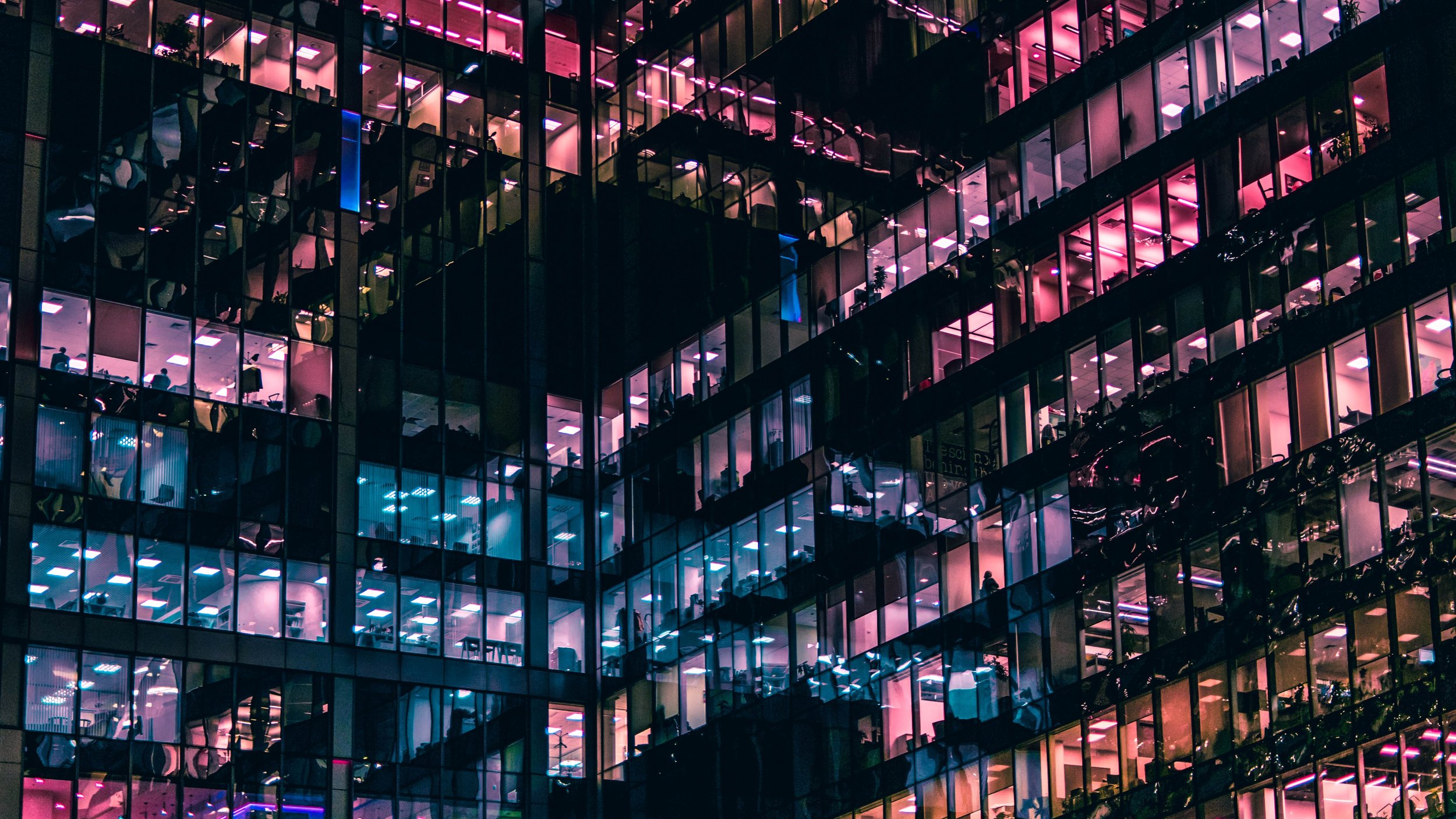 colourful photograph of lights reflecting off of office buildings